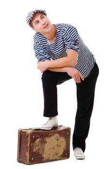 Full length stylish traveler dreaming man with vintage suitcase isolated on white background