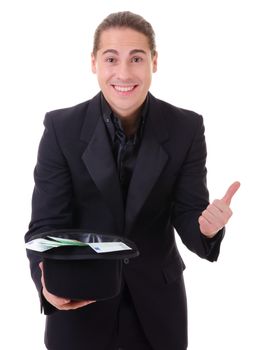 Paper money cash in euro from a hat demonstrated by man in black suit. Isolated on white.