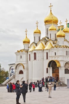 Tourists near the Cathedral of the Annunciation in Mosev, Russia, September 30, 2011. Annunciation Cathedral - Orthodox Christian Church of the Annunciation of the Virgin Mary, located in Cathedral Square of the Moscow Kremlin.