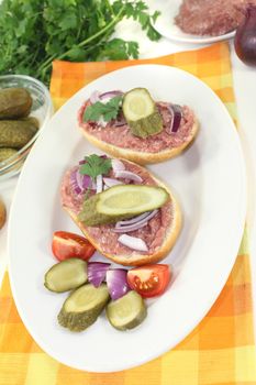 white bread with pickles and onions on a light background