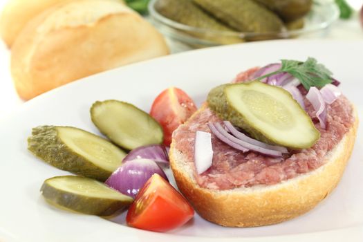 fresh white bread with pickles on a light background