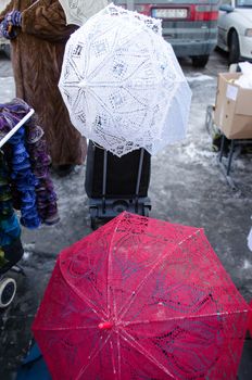 crochet tatting handmade craft decorative umbrella sell in outdoor street market fair.