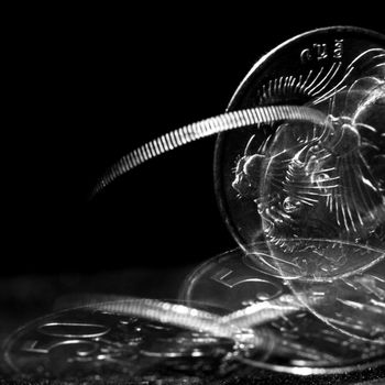 Stroboscopic effect created using flash capturing the motion of a coin as it is spinning