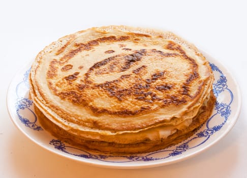 The stack of ruddy tasty pancakes on the plate