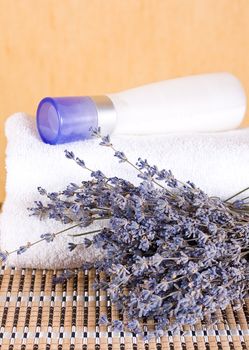 Cream with extracts of lavender and lavender flowers with a towel