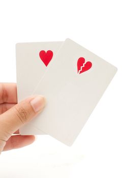 Playing cards with heart symbols representing love risk 