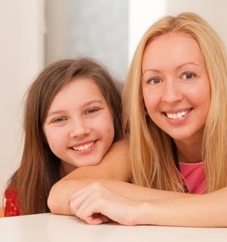 Happy beautiful caucasian sisters at home