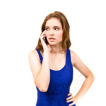 An attractive teen poses for a photo indoors in a lighting studio against a white background with a fashion style feel to the image.