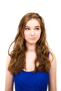 An attractive teen poses for a photo indoors in a lighting studio against a white background with a fashion style feel to the image.