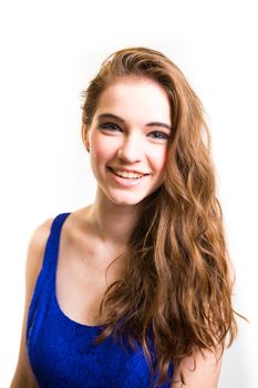 An attractive teen poses for a photo indoors in a lighting studio against a white background with a fashion style feel to the image.