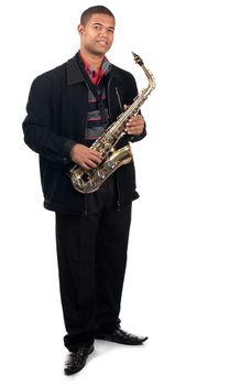 A proud young saxophonist holds his instrument.