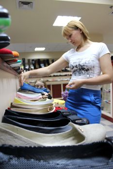 image of shoe young woman chooses shoe in shoe shop