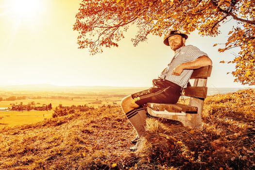 A traditional bavarian man in the autumn nature