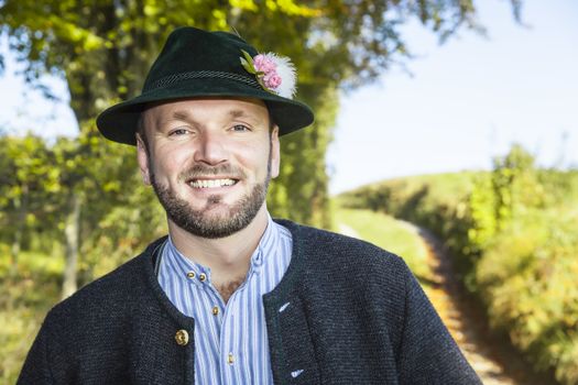 A traditional bavarian man in the autumn nature