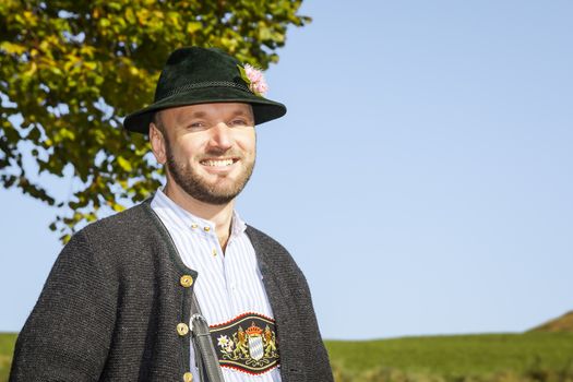 A traditional bavarian man in the autumn nature