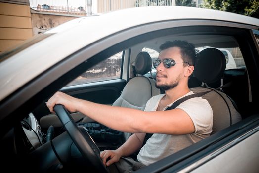 stylish man driving car in the city