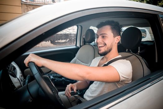 stylish man driving car in the city