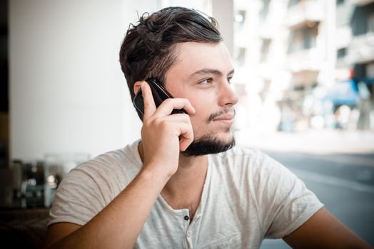young stylish man on the phone in the bar