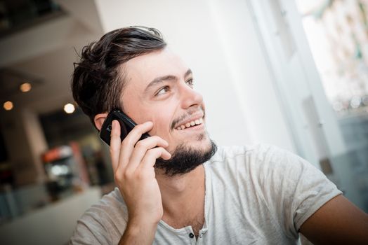 young stylish man on the phone in a bar