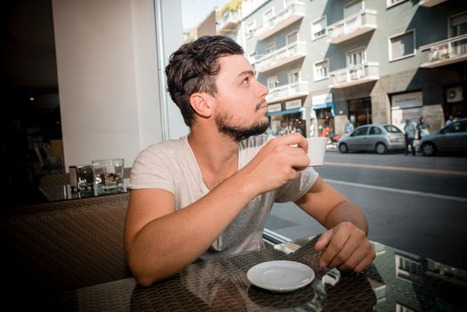 young stylish man drinking coffee in a bar







young stylish man drinking coffee