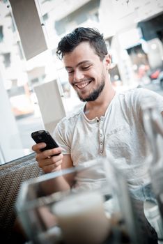 young stylish man in a bar in the city