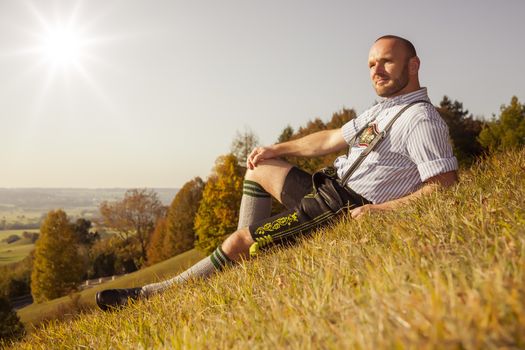 A traditional bavarian man in the autumn nature