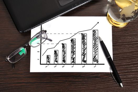 workplace with growth chart on paper