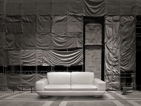 White leather sofa, construction site scaffold tarpaulin canvas background