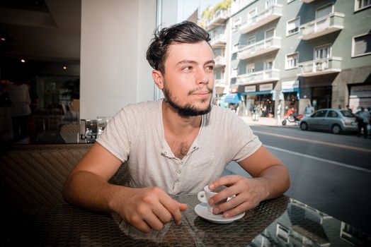 young stylish man in a bar in the city