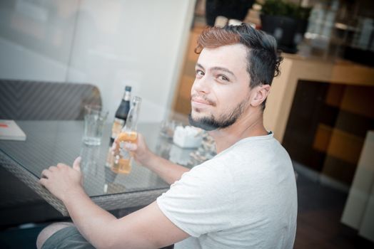 young stylish man in a bar in the city