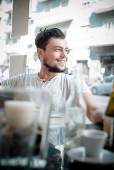 young stylish man in a bar in the city