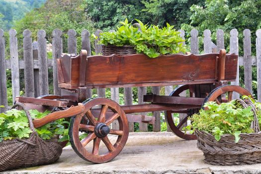 Wooden cart and wicker baskets in the back yard