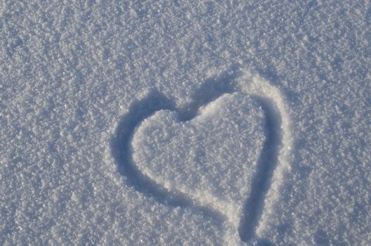 Simple heart shape figure draw on snow symbolize concept of winter love.