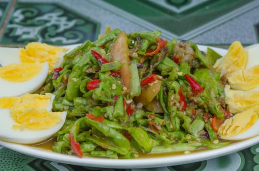 close up String bean spicy salad on plate served boiled egg , asian spicy salad