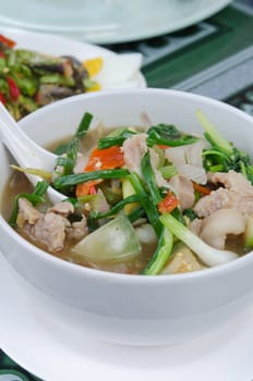 close up top  spicy pork soup made from spices and vegetable in white bowl