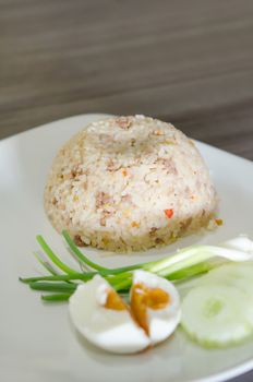  fried rice with pork served with salted egg and fresh vegetable