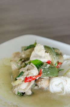 green chicken curry served with  rice vermicelli in white plate 