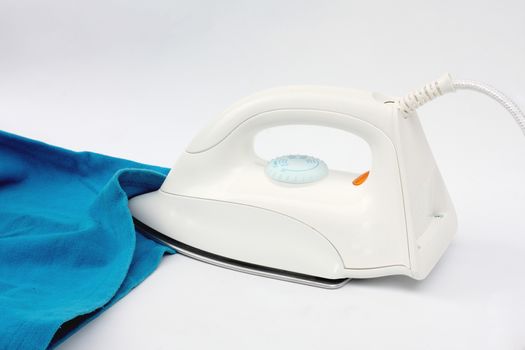 Electric iron and shirt, on white and blue background