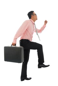 Full body young Asian businessman climbing virtual ladder with briefcase, isolated on white background