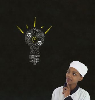 Bright idea gear cog lightbulb thinking African or African American woman chef on chalk blackboard background