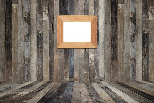 Wooden picture frame on the old wooden wall