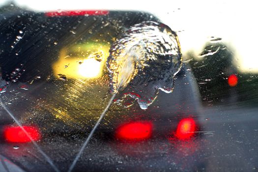 A car through a wet windshield