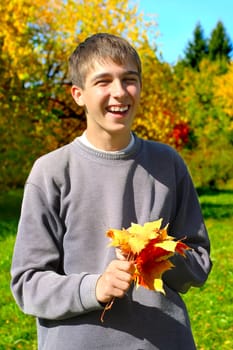 teenager with autumn leafs in the park