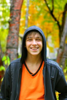 smiling teenager stand in the autumn park