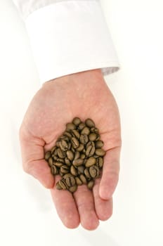 Top view of male hand holding coffee beans.
