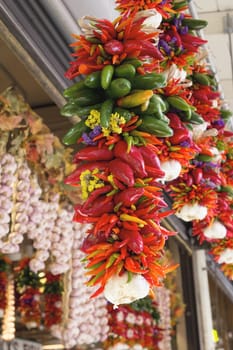 Colorful Hot Chili Jalapeno and Cayenne Peppers and Garlic Bunches Hanging at Fruits and Vegetable Stall