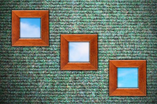 grungy wall with carpet texture and three wooden frames with blue sky 