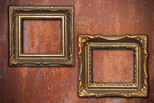 ancient wooden frames on rusty metal wall background