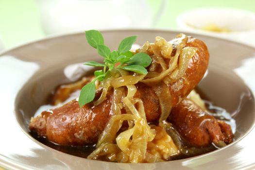 The classic English meal of bangers and mash with gravy ready to serve.