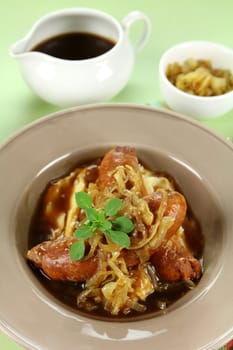 The classic English meal of bangers and mash with gravy ready to serve.